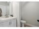 Modern half bathroom featuring a white vanity, sleek faucet, and toilet at 2604 N 27Th St # 17, Phoenix, AZ 85008