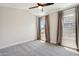 Bedroom featuring high ceilings, neutral paint, carpet, and two bright windows at 2604 N 27Th St # 17, Phoenix, AZ 85008