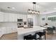 Well-lit kitchen featuring white cabinets, stainless steel appliances, and a quartz countertop island at 2604 N 27Th St # 17, Phoenix, AZ 85008