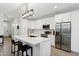 Modern kitchen featuring white cabinets, a quartz countertop island, and stainless steel appliances at 2604 N 27Th St # 17, Phoenix, AZ 85008