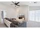 Cozy loft featuring a gray sofa, ceiling fan, and natural light from large windows at 2604 N 27Th St # 17, Phoenix, AZ 85008