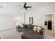 Upstairs loft with gray sectional sofa, ceiling fan, and access to laundry room at 2604 N 27Th St # 17, Phoenix, AZ 85008