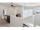 Open loft area with a comfortable gray sofa, large windows and a ceiling fan at 2604 N 27Th St # 17, Phoenix, AZ 85008