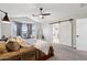 Main bedroom with a ceiling fan, bay windows, and sliding barn door to the bathroom at 2604 N 27Th St # 17, Phoenix, AZ 85008