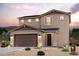 Charming two-story home with a two-car garage and desert landscaping, offering modern comfort and curb appeal at 2611 E Music Mountain Ave, Apache Junction, AZ 85119