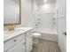 Bathroom features a shower over tub and a vanity with modern fixtures and storage at 297 W Tamarack Dr, San Tan Valley, AZ 85140