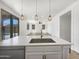 Modern kitchen boasts stainless steel appliances, a spacious island, and stylish pendant lighting at 297 W Tamarack Dr, San Tan Valley, AZ 85140