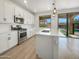 Modern kitchen featuring an island, stainless steel appliances, and a breakfast bar with outside views at 297 W Tamarack Dr, San Tan Valley, AZ 85140