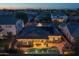 Sunset aerial of home featuring a pool, outdoor seating and kitchen area, and solar panels at 3049 E Longhorn Dr, Gilbert, AZ 85297