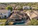 A high aerial view of the home displaying the pool, patio, solar panels, and lush surrounding neighborhood at 3049 E Longhorn Dr, Gilbert, AZ 85297