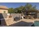 Inviting outdoor space with pizza oven, barbecue, bar and covered pergola for relaxing and entertaining friends at 3049 E Longhorn Dr, Gilbert, AZ 85297