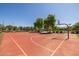 Red basketball court with clear blue sky and green landscaping, promoting outdoor recreation at 3049 E Longhorn Dr, Gilbert, AZ 85297