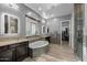 This primary bathroom features dual sinks, separate bathtub, walk-in shower, and large walk-in closet at 3049 E Longhorn Dr, Gilbert, AZ 85297
