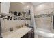 A bathroom features a vanity sink, toilet, bathtub, and decorative tile accents at 3049 E Longhorn Dr, Gilbert, AZ 85297