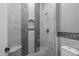 The tiled bathroom has a shower stall, niche and decorative tile accent stripe at 3049 E Longhorn Dr, Gilbert, AZ 85297