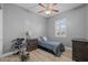 This bedroom features a ceiling fan and shuttered windows for climate control and privacy at 3049 E Longhorn Dr, Gilbert, AZ 85297