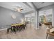 Open dining room with modern chandelier, neutral paint and tile flooring, flowing to the living spaces at 3049 E Longhorn Dr, Gilbert, AZ 85297