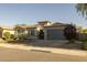 Attractive home featuring a tiled roof, desert landscaping, stone accents, and a two-car garage, ideal for comfortable Gathering living at 3049 E Longhorn Dr, Gilbert, AZ 85297