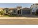 Charming single-story home with stone accents, a well-manicured lawn, and a two-car garage at 3049 E Longhorn Dr, Gilbert, AZ 85297
