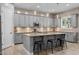 Beautiful kitchen featuring gray cabinets, granite countertops, a large island and stylish pendant lighting at 3049 E Longhorn Dr, Gilbert, AZ 85297