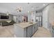 Open-concept kitchen with gray cabinets, a granite island, stainless steel appliances, and an inviting atmosphere at 3049 E Longhorn Dr, Gilbert, AZ 85297