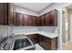 Bright laundry room with ample cabinet space, marble countertops, and stainless steel washer and dryer at 3049 E Longhorn Dr, Gilbert, AZ 85297