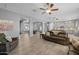 Open-concept living room with tile flooring, neutral walls, and seamless flow to the kitchen and dining areas at 3049 E Longhorn Dr, Gilbert, AZ 85297