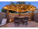 Custom outdoor kitchen island featuring stone counter with a grill and bar seating at 3049 E Longhorn Dr, Gilbert, AZ 85297