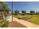 Scenic park view featuring a covered bench, stone walls, walking path and well-manicured green space at 3049 E Longhorn Dr, Gilbert, AZ 85297