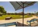 Shaded seating at community park, grassy field, and walking path creates inviting space for residents at 3049 E Longhorn Dr, Gilbert, AZ 85297