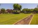 Neighborhood park featuring a walking path, open green space, mature shade trees and a playground at 3049 E Longhorn Dr, Gilbert, AZ 85297
