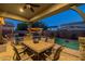 Charming covered patio featuring an outdoor dining area, a built-in grill, and a refreshing pool at 3049 E Longhorn Dr, Gilbert, AZ 85297