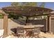 Close-up of backyard kitchen with bar, BBQ grill, and covered pergola, providing the ultimate entertaining space at 3049 E Longhorn Dr, Gilbert, AZ 85297