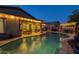 Gorgeous backyard featuring a refreshing pool, covered patio, built-in grill, and lush desert plants at 3049 E Longhorn Dr, Gilbert, AZ 85297
