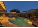 Backyard oasis featuring a pool, waterfall, lush landscaping, and an outdoor kitchen area at 3049 E Longhorn Dr, Gilbert, AZ 85297