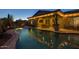 Stunning backyard pool with water feature, covered patio, and beautiful desert landscaping at 3049 E Longhorn Dr, Gilbert, AZ 85297