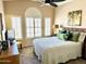 This bedroom has a fan, shutters, and a tropical theme at 3440 E Southern Ave # 1088, Mesa, AZ 85204