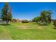 Common area with large grassy field and mature trees at 3440 E Southern Ave # 1088, Mesa, AZ 85204