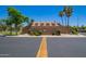 View of the neighborhood community center with lush trees at 3440 E Southern Ave # 1088, Mesa, AZ 85204