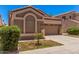 Alluring home showcasing a two-car garage, desert landscaping, manicured lawn, and timeless architectural appeal at 3440 E Southern Ave # 1088, Mesa, AZ 85204