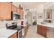 Bright kitchen showcases wood cabinetry, stainless steel appliances, and seamless flow into the entryway at 3440 E Southern Ave # 1088, Mesa, AZ 85204