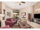 Well-lit living room with a fireplace, sliding glass door to patio, stylish furnishings and neutral color palette at 3440 E Southern Ave # 1088, Mesa, AZ 85204