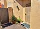 Inviting outdoor patio area with stylish potted plants, a decorative art piece, and charming exterior lighting at 3440 E Southern Ave # 1088, Mesa, AZ 85204