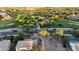 Aerial shot showcasing a neighborhood park near homes with swimming pools and mature trees at 3622 E Sparrow Pl, Chandler, AZ 85286