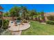 Serene backyard showcasing a pool, mature trees, a rock feature, and a stamped concrete patio with outdoor seating at 3622 E Sparrow Pl, Chandler, AZ 85286