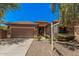 Single-story home with a tile roof, two-car garage, and desert landscaping for low maintenance at 3622 E Sparrow Pl, Chandler, AZ 85286