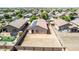 Aerial view of a fenced backyard with desert landscaping and solar panels on the home at 40027 W Pryor Ln, Maricopa, AZ 85138