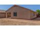 Tan home featuring a covered patio with a fenced gravel and dirt backyard at 40027 W Pryor Ln, Maricopa, AZ 85138