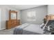 A bedroom featuring a wooden dresser, a window, and carpet flooring at 40027 W Pryor Ln, Maricopa, AZ 85138