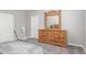 Bedroom featuring a wooden dresser, carpet flooring and white doors at 40027 W Pryor Ln, Maricopa, AZ 85138